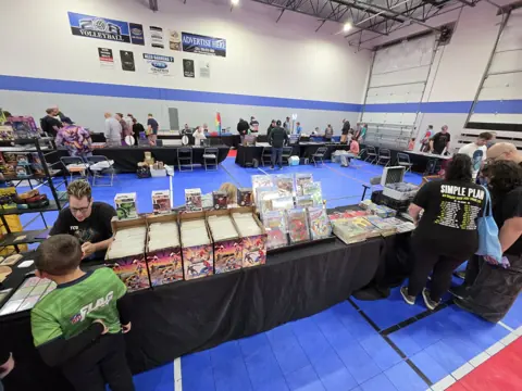 Wide view of Dan’s Sweet Pickins booth with comics and collectible displays