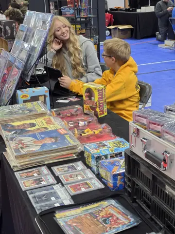 Family members sharing a moment at the card-show table